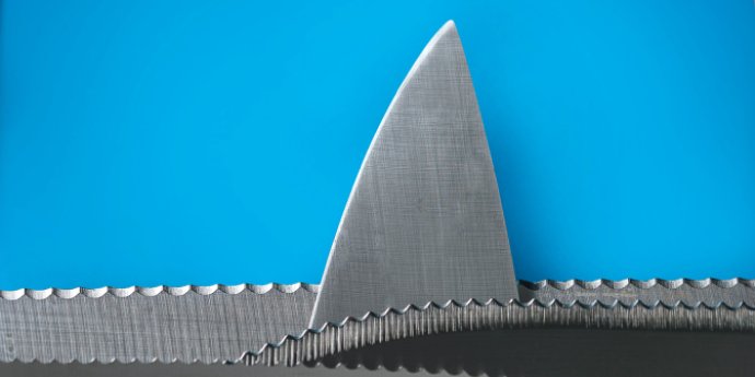 Shark fin in a sea made of chainsaw teeth with blue background