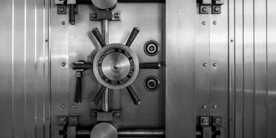 A monochrome image depicting a solid metal door, showcasing its industrial design and smooth finish.