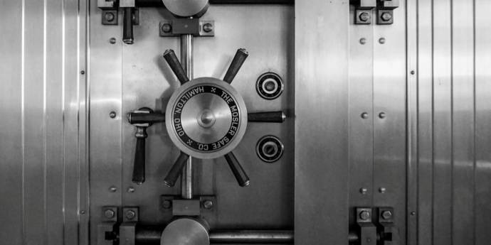 A monochrome image depicting a solid metal door, showcasing its industrial design and smooth finish.