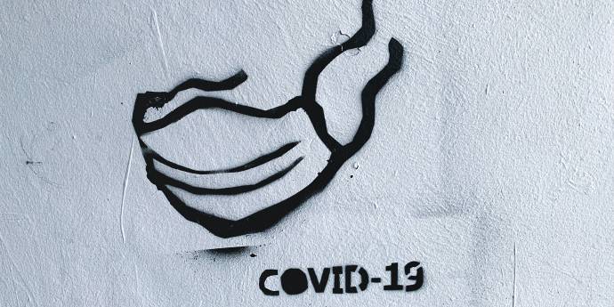 black covid mask stencil painting on wall 