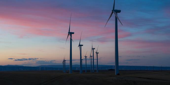Windmills in landscape at dusk