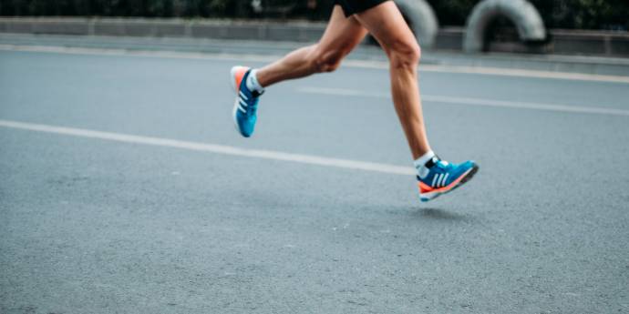 Athlete's feet running on road