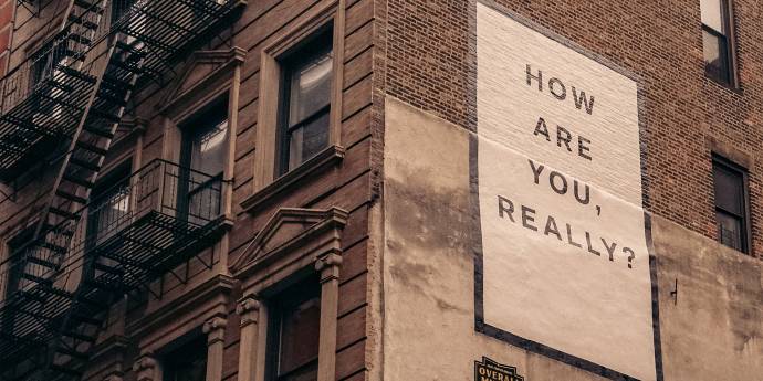 Old building with sign how are you really?