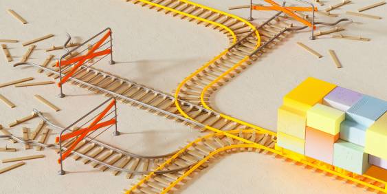 Yellow train tracks split in several directions with safety barriers in place