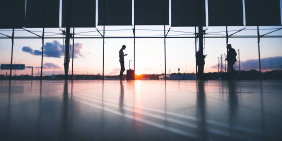 A business woman pulling a suitcase