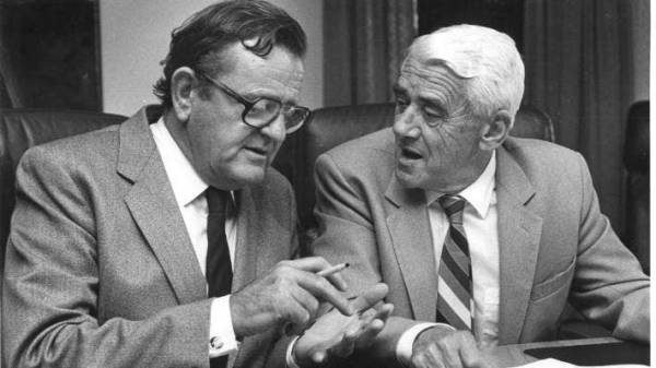 Sir Ron Trotter, left, and Sir Ron Weir in 1986, discussing the final points of the merger of Wrightson and Dalgety, creating one of New Zealand’s largest rural companies.