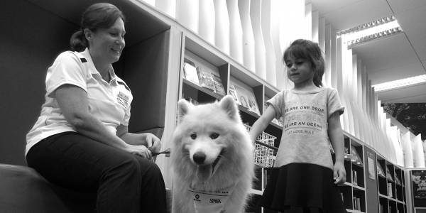 Nurse and a girl with a white husky dog from SPCA