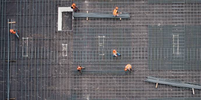 Looking from above at construction workers on a site