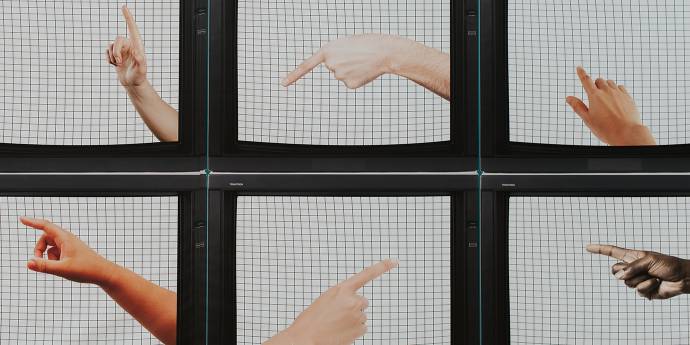 Television screens in array with fingers on the screens pointing in different directions