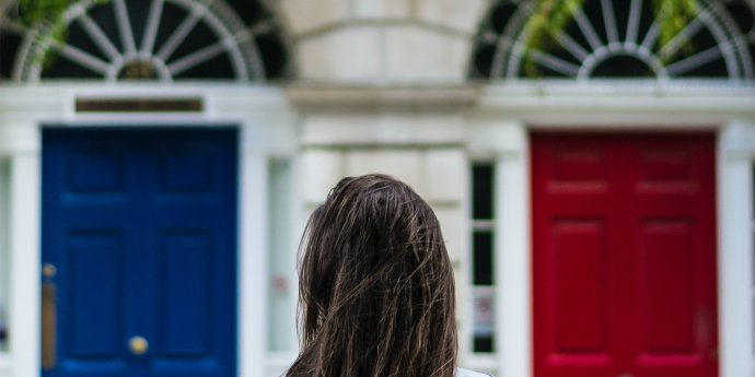 Woman choosing between coloured doors