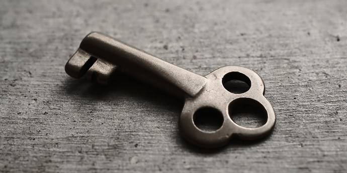 old brass key on a wooden table