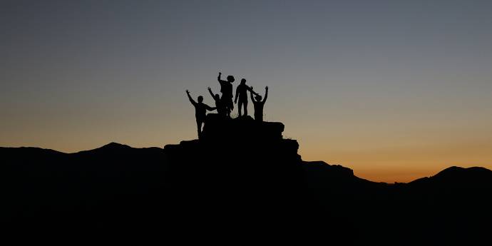 Silhouette of a group of people on a hill