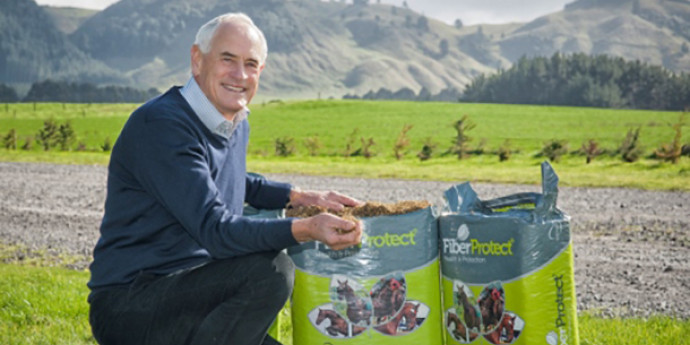 Michael Bell on a farm with bags of fibre protect product