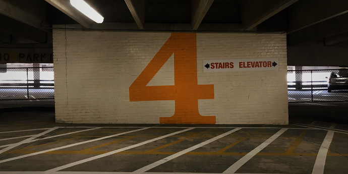 The number four painted on a carpark brick wall